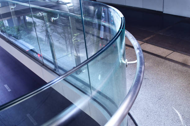 Curve tempered laminated glass railing balustrade panels frame less ,safety glass for modern architectural buildings. Concept for Aluminum balcony or terrace design with glazing profile. Company and industry portfolio image.